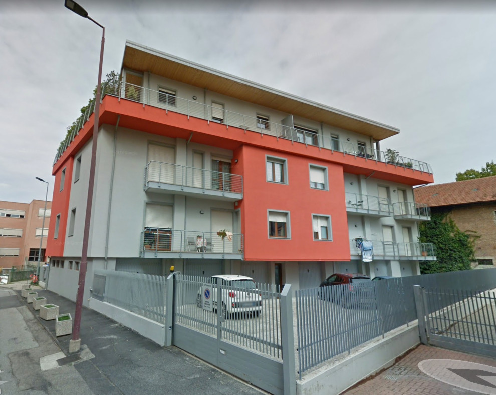 Mid-sized contemporary multicolored three-story flat roof idea in Turin with a metal roof