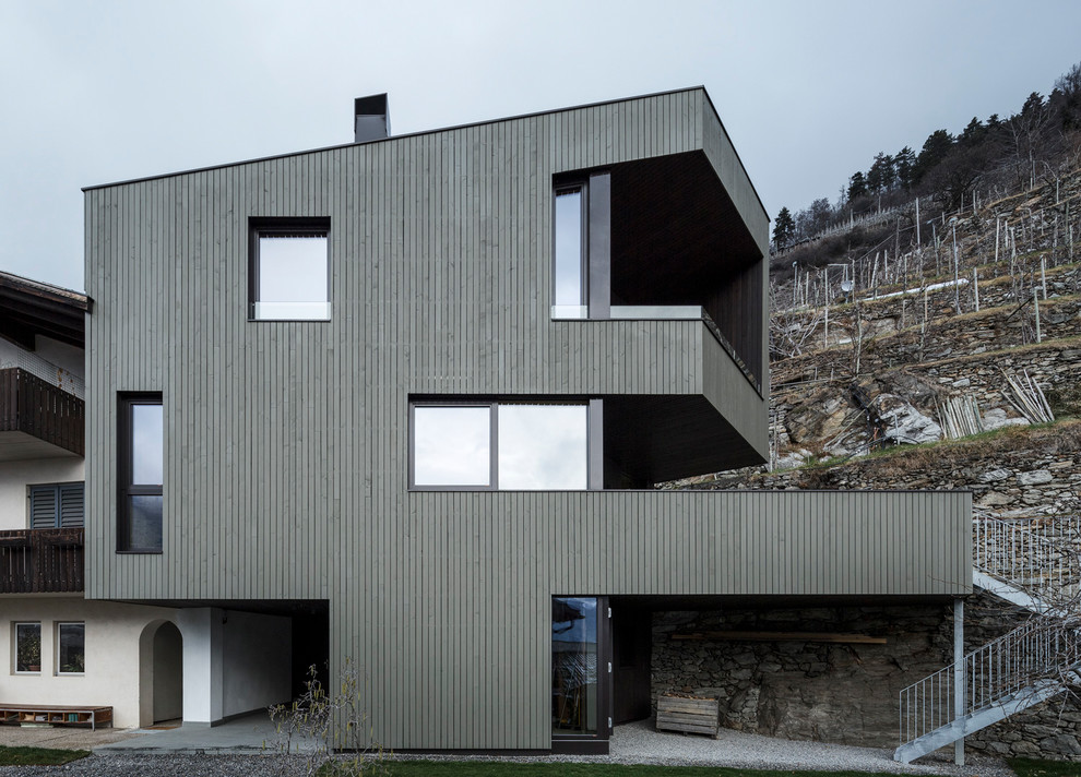 Ispirazione per la facciata di una casa grande contemporanea a tre piani con rivestimento in legno e tetto piano