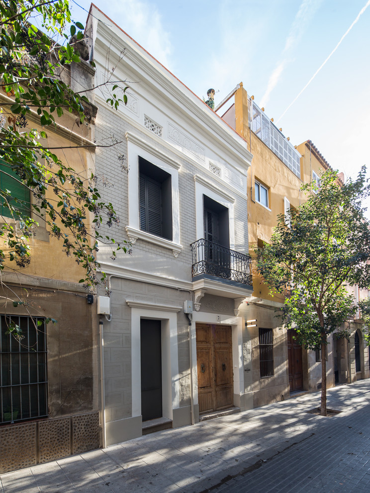 Inspiration for a small timeless three-story mixed siding exterior home remodel in Barcelona