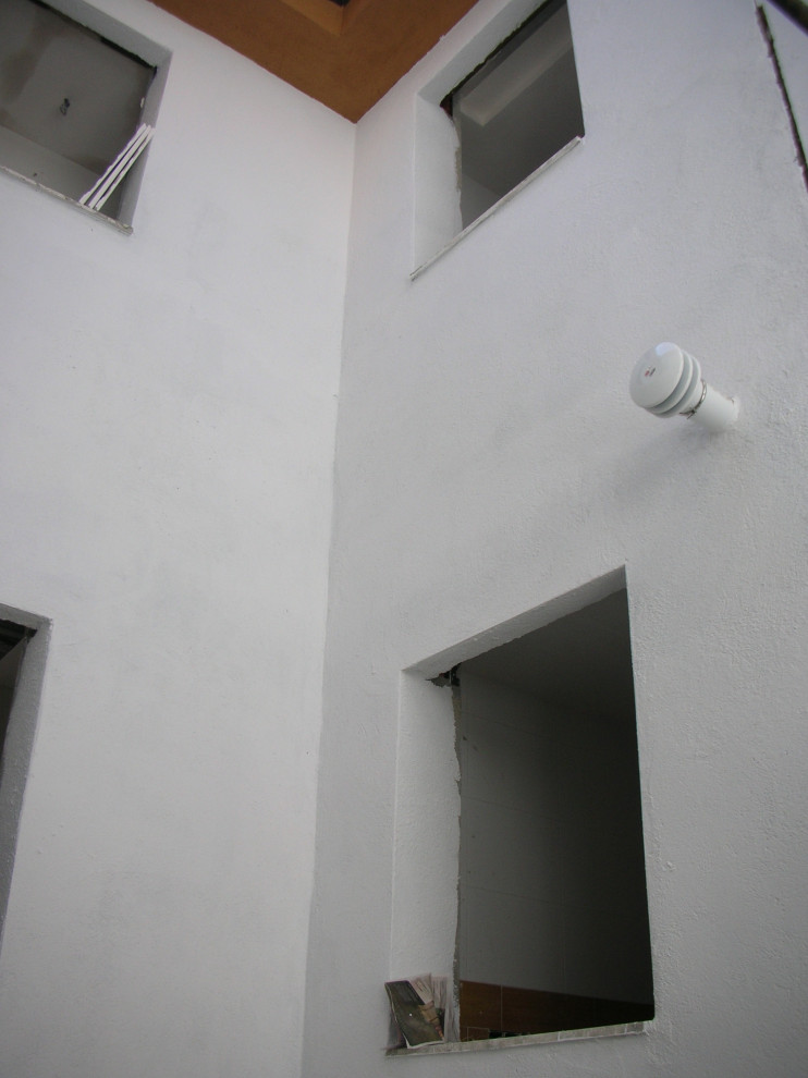 Idee per la facciata di un appartamento ampio bianco moderno a quattro piani con rivestimento in mattone verniciato, tetto a capanna e copertura in tegole