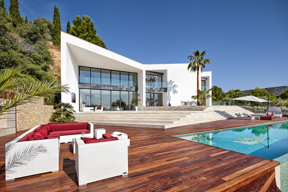 Large trendy white two-story house exterior photo in Palma de Mallorca with a shed roof