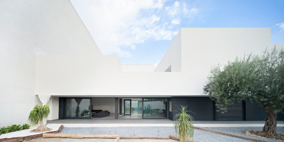 Diseño de fachada blanca contemporánea grande de dos plantas con revestimiento de estuco y tejado plano