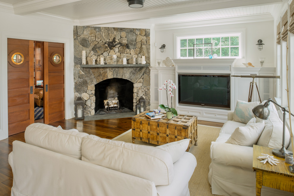 Photo of a large nautical enclosed games room in Providence with white walls, medium hardwood flooring, a standard fireplace and a stone fireplace surround.