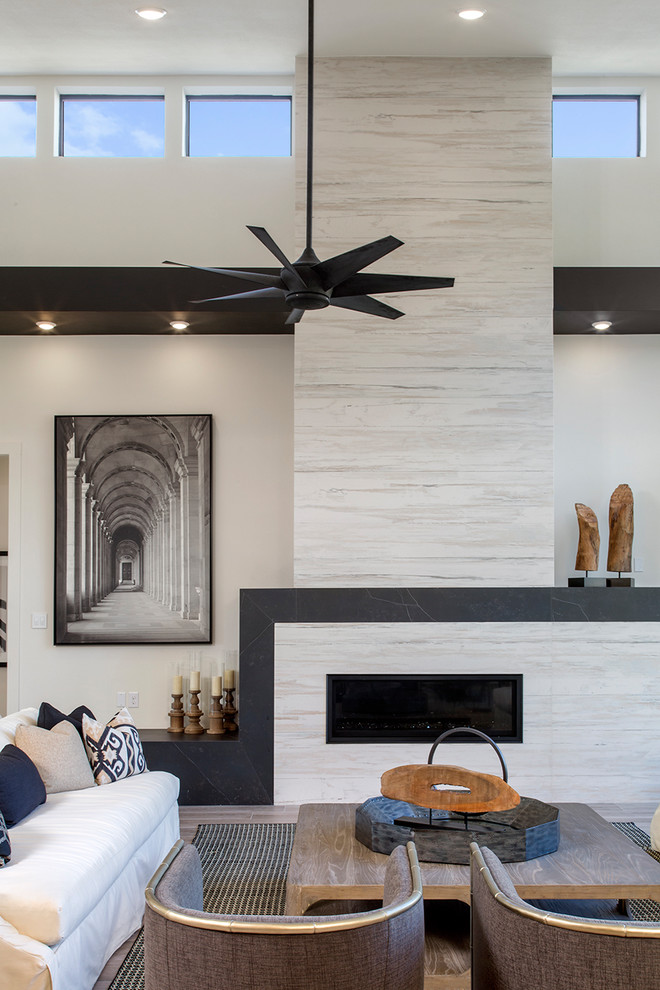 Inspiration for an industrial porcelain tile family room remodel in Other with white walls