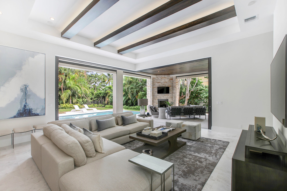 Inspiration for a transitional family room remodel in Miami with white walls and a wall-mounted tv