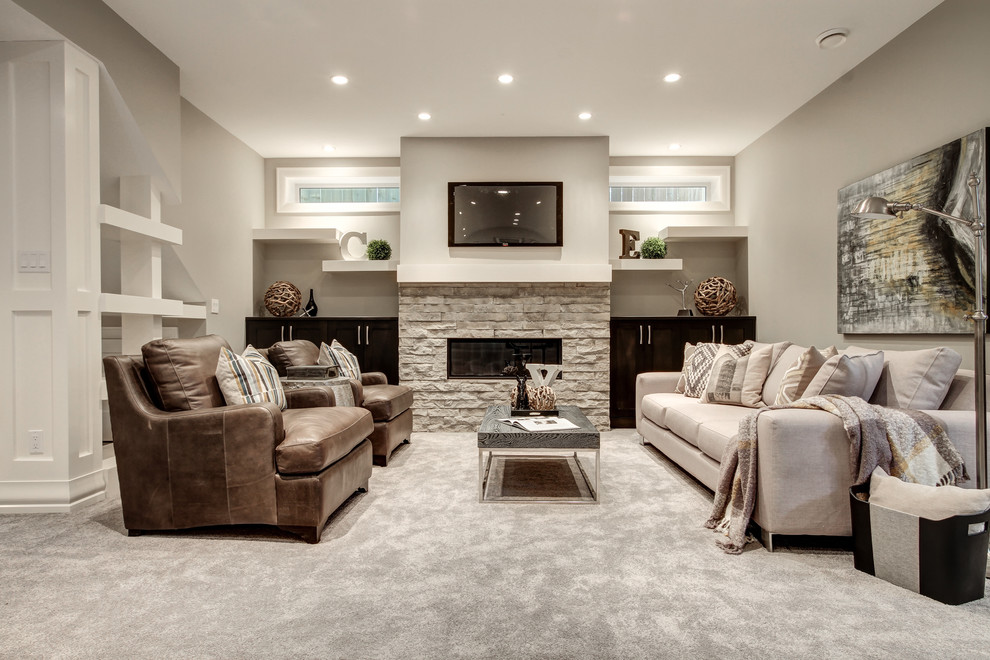 Large classic open plan games room in Calgary with a game room, grey walls, carpet, a standard fireplace, a stone fireplace surround and a wall mounted tv.