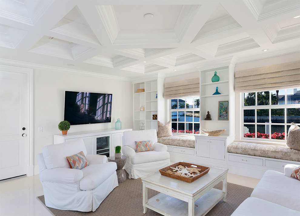 This is an example of a medium sized beach style enclosed games room in Other with white walls, porcelain flooring, no fireplace, a wall mounted tv and beige floors.