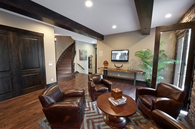 Example of a mid-sized classic open concept dark wood floor and brown floor family room design in Portland with beige walls