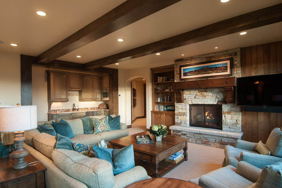 Inspiration for a traditional games room in Salt Lake City with beige walls, carpet, a standard fireplace, a stone fireplace surround and a wall mounted tv.