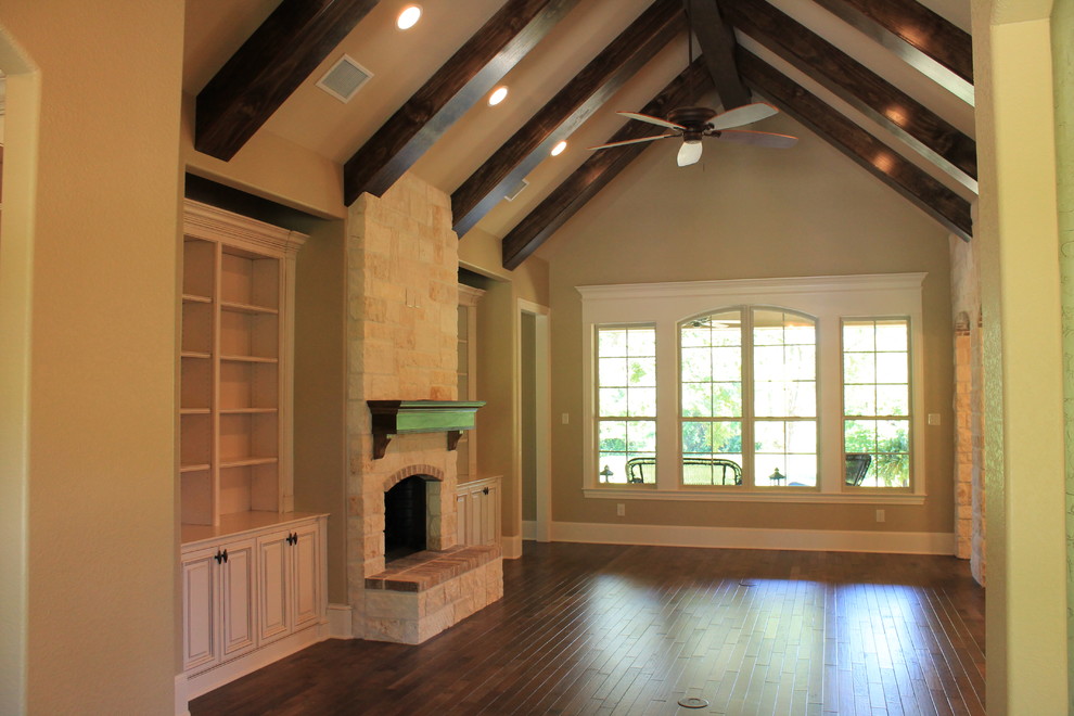 Design ideas for a medium sized traditional games room in Dallas with beige walls, dark hardwood flooring, a standard fireplace and a stone fireplace surround.