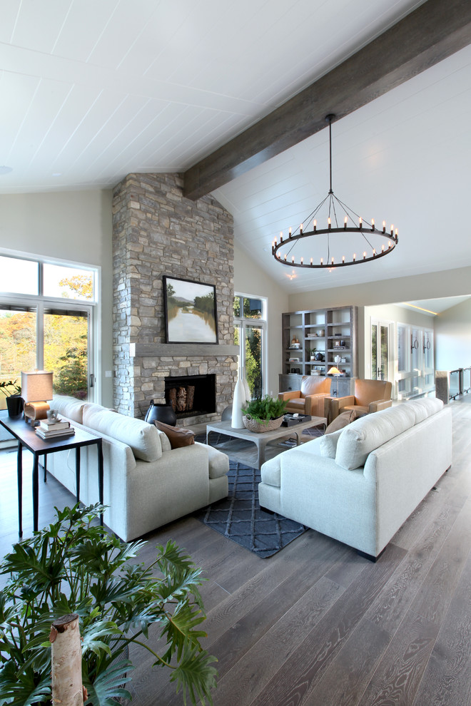 Inspiration for a large transitional open concept medium tone wood floor family room remodel in Grand Rapids with beige walls, a stone fireplace and a standard fireplace