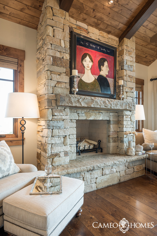 Family room - large rustic open concept dark wood floor family room idea in Salt Lake City with white walls, a standard fireplace, a stone fireplace and a media wall