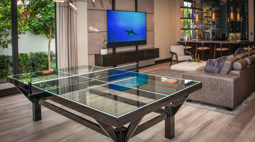 Family room - mid-sized contemporary medium tone wood floor and brown floor family room idea in Miami