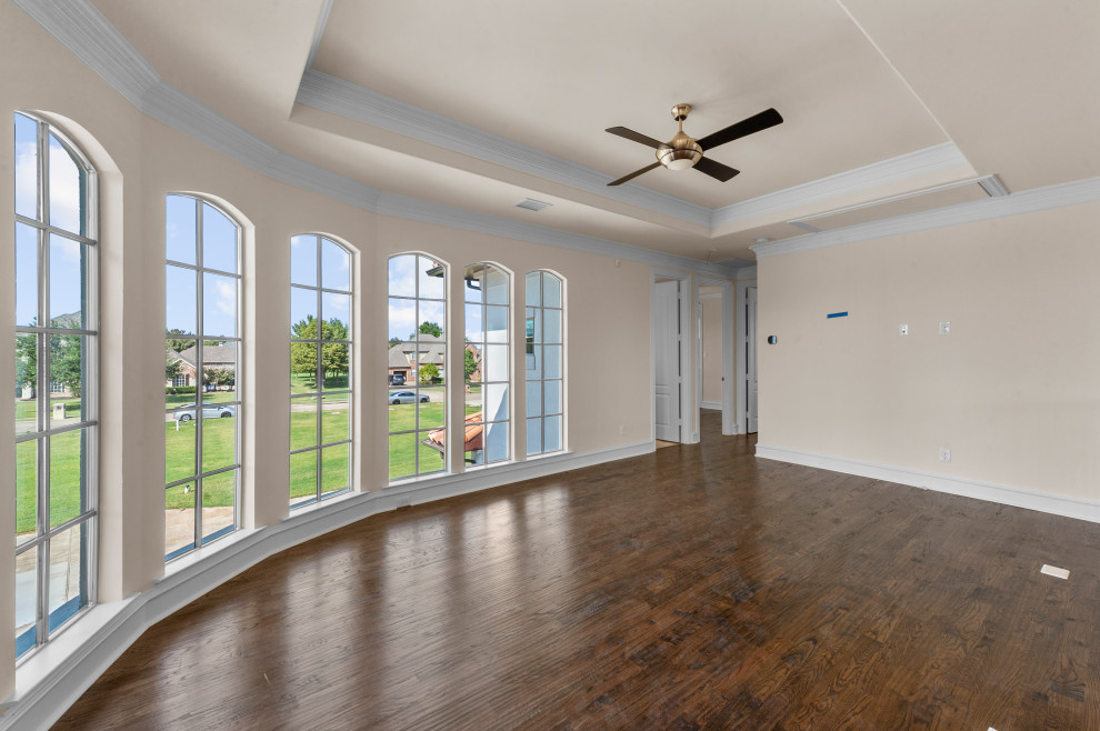 Large mediterranean open plan games room in Dallas with white walls, a wall mounted tv, a game room, dark hardwood flooring, brown floors and a drop ceiling.