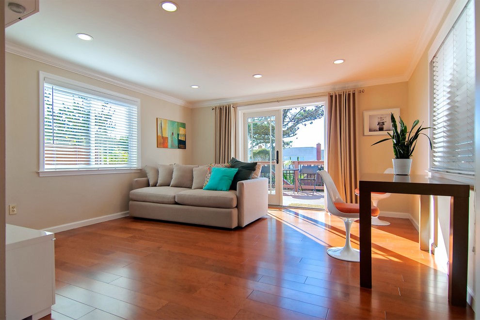 Inspiration for a medium sized contemporary enclosed games room in San Francisco with a game room, a concealed tv, beige walls and light hardwood flooring.