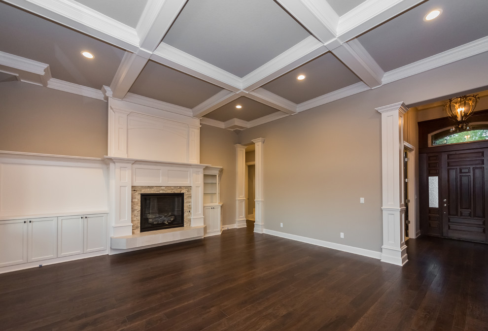 Inspiration for a large traditional open plan games room in Portland with grey walls, dark hardwood flooring, a standard fireplace, a stone fireplace surround and no tv.