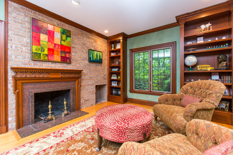 Example of a trendy enclosed carpeted family room library design in Boston with green walls, a standard fireplace and a concealed tv