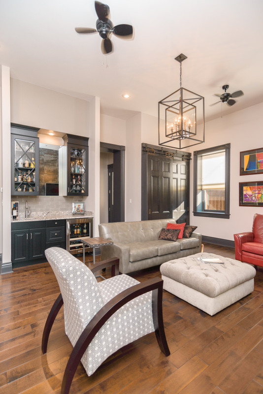 This is an example of a medium sized classic open plan games room in St Louis with a home bar, grey walls, medium hardwood flooring, a ribbon fireplace, a tiled fireplace surround and a wall mounted tv.