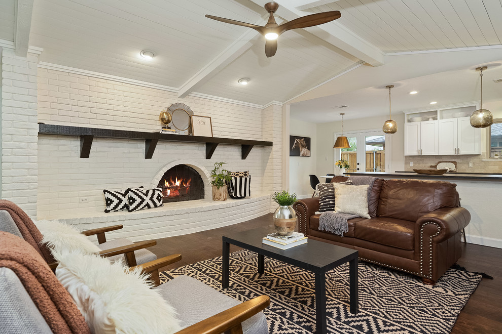 Inspiration for a classic open plan living room in Dallas with white walls, dark hardwood flooring, a standard fireplace and a brick fireplace surround.