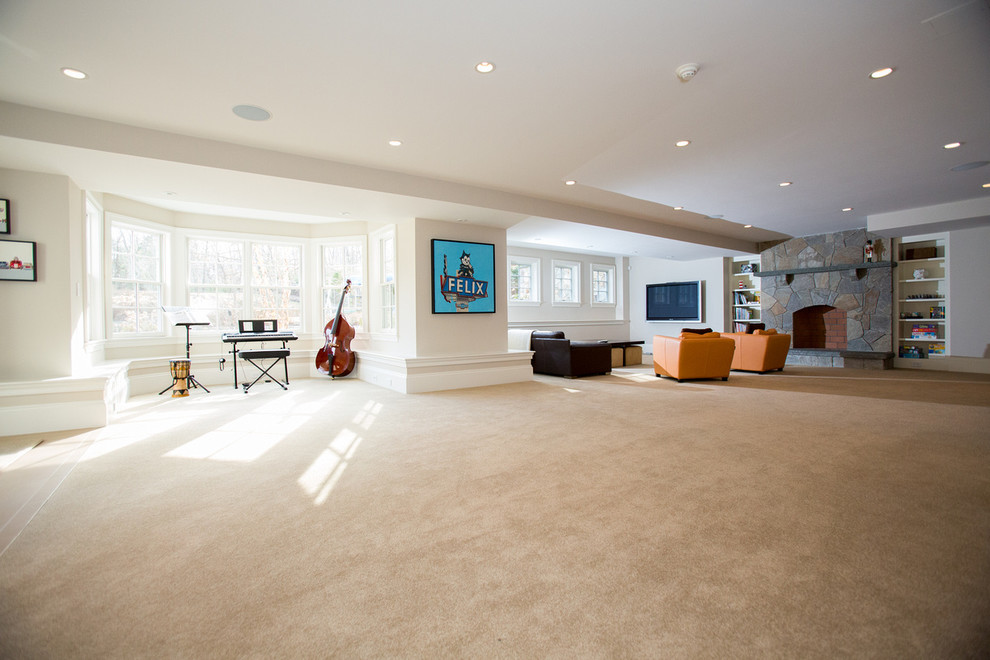 Foto de sala de estar abierta clásica con paredes beige, suelo de madera en tonos medios, todas las chimeneas, marco de chimenea de piedra y televisor colgado en la pared