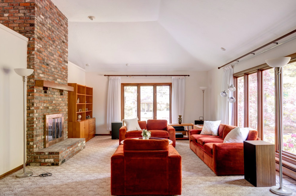 Large contemporary open plan games room in Boston with white walls, carpet, a standard fireplace, a brick fireplace surround and beige floors.