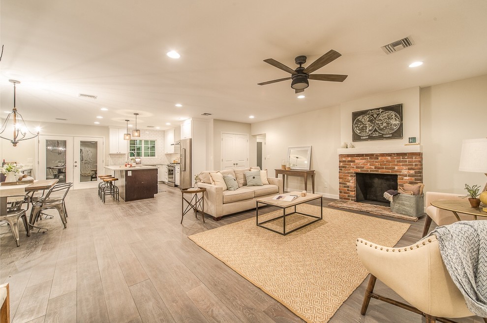 Design ideas for a medium sized classic open plan games room in Phoenix with grey walls, light hardwood flooring, a standard fireplace, a brick fireplace surround and no tv.