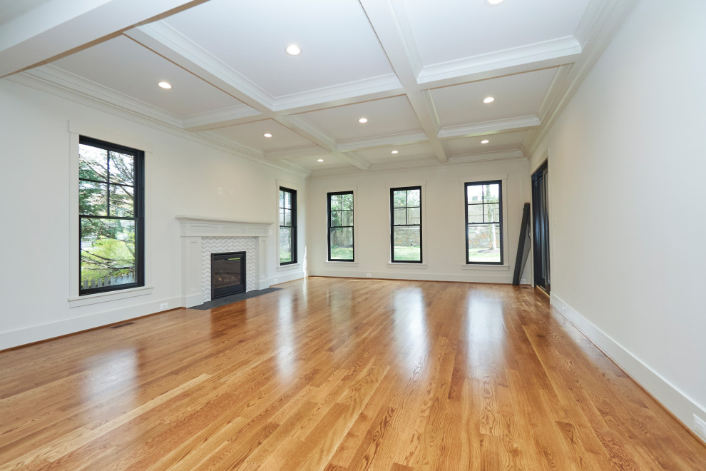 Inspiration for a large traditional open plan games room in DC Metro with white walls, medium hardwood flooring, a standard fireplace, a tiled fireplace surround, a wall mounted tv and brown floors.