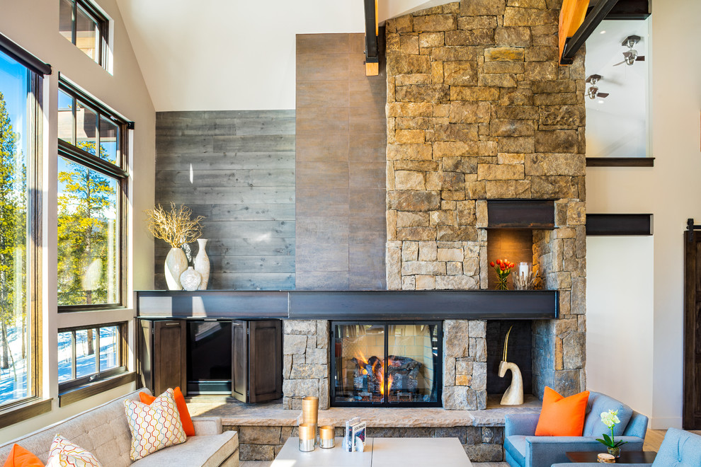Family room - rustic family room idea in Denver with a standard fireplace and a concealed tv