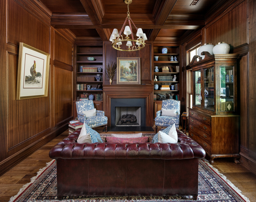 Inspiration for a timeless medium tone wood floor, brown floor, coffered ceiling and wood wall family room library remodel in Charleston with brown walls, a standard fireplace, a stone fireplace and no tv