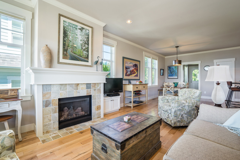 Mid-sized beach style open concept light wood floor family room photo in Seattle with beige walls, a standard fireplace and a stone fireplace
