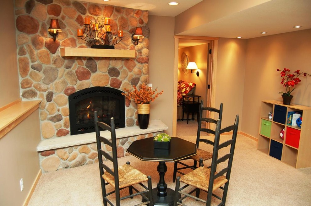 Inspiration for a mid-sized contemporary enclosed carpeted family room remodel in Portland with brown walls, a standard fireplace, a stone fireplace and no tv