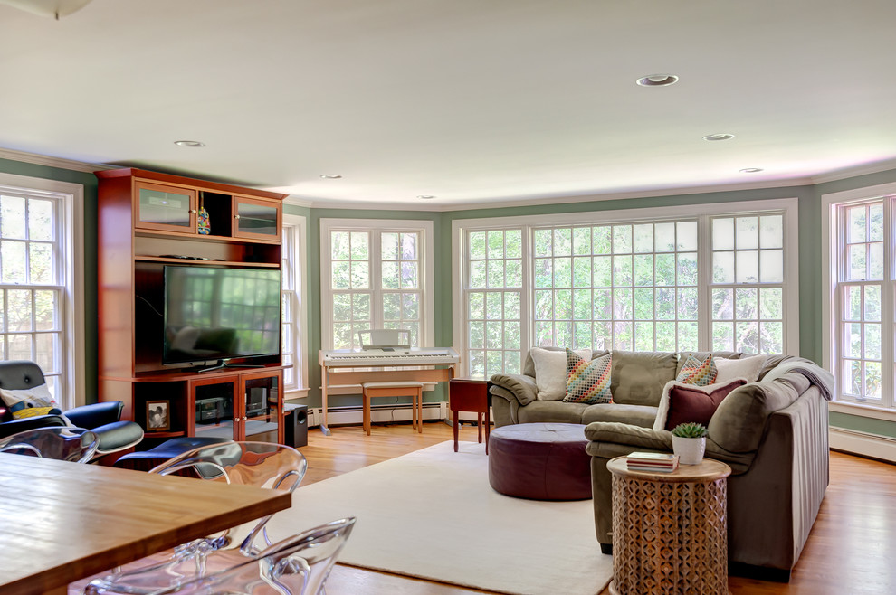 Large elegant open concept medium tone wood floor family room photo in Boston with a music area, green walls and a media wall