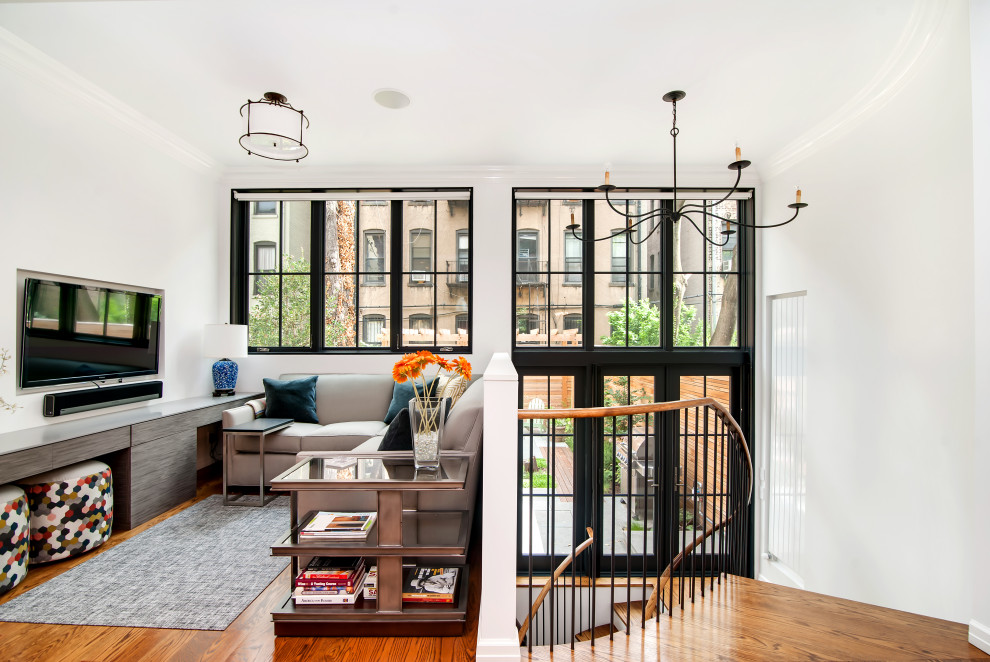 Mittelgroßes Modernes Wohnzimmer im Loft-Stil mit weißer Wandfarbe, braunem Holzboden, TV-Wand und braunem Boden in New York