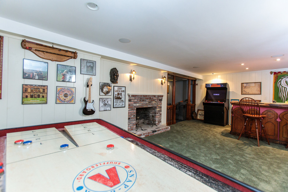This is an example of a large classic open plan games room in Boston with a game room, carpet, a standard fireplace and a stone fireplace surround.