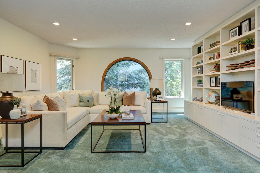 Example of a transitional carpeted family room library design in Calgary with white walls, no fireplace and a tv stand