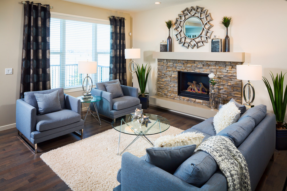 Inspiration for a contemporary living room in Calgary with beige walls, dark hardwood flooring, a standard fireplace, a stone fireplace surround, no tv and brown floors.