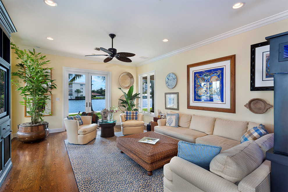 Mid-sized island style enclosed carpeted and beige floor family room photo in Miami with a bar, beige walls, no fireplace and no tv