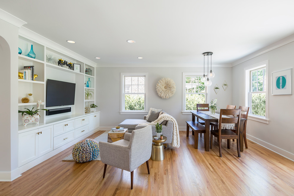 Example of a small transitional open concept light wood floor family room design in Minneapolis with no fireplace, a media wall and gray walls