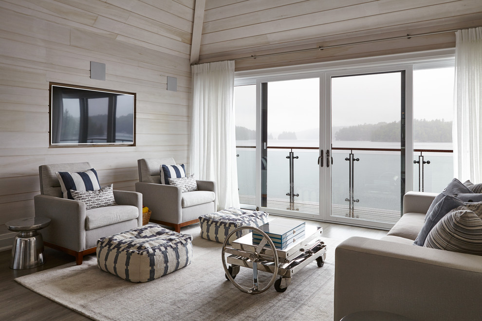 Foto de salón para visitas abierto costero grande con pared multimedia, paredes beige, suelo de madera clara y suelo gris