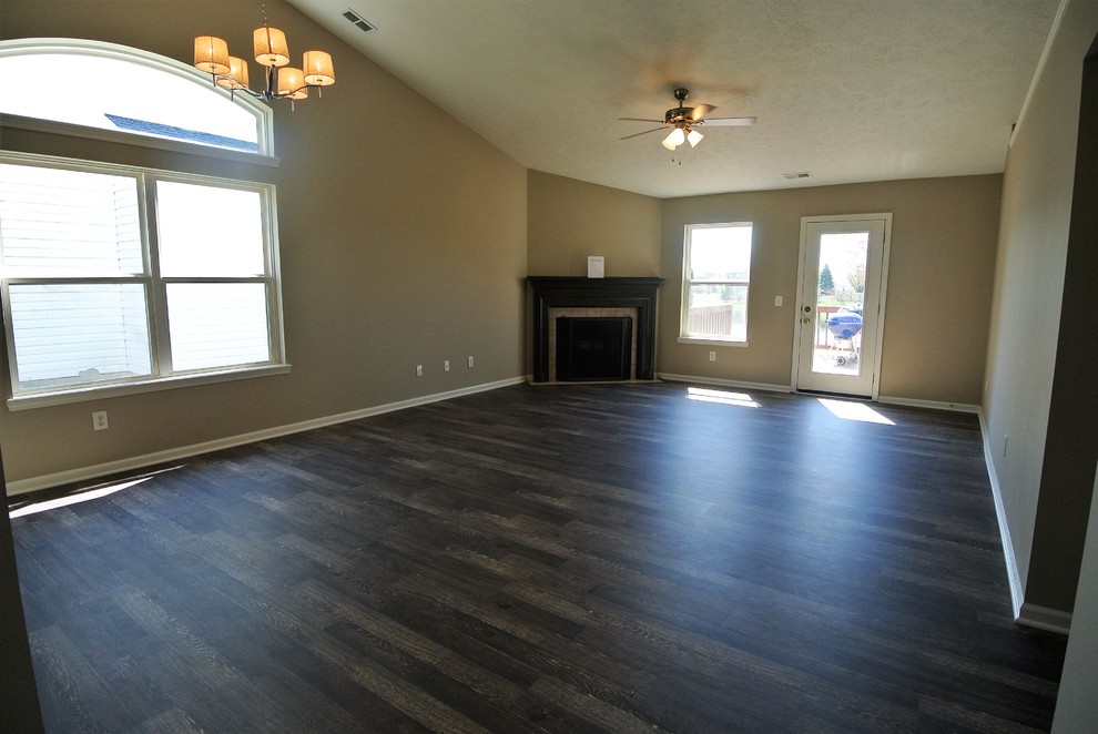 Inspiration for a large transitional open concept dark wood floor family room remodel in Indianapolis with beige walls, a corner fireplace, a tile fireplace and no tv