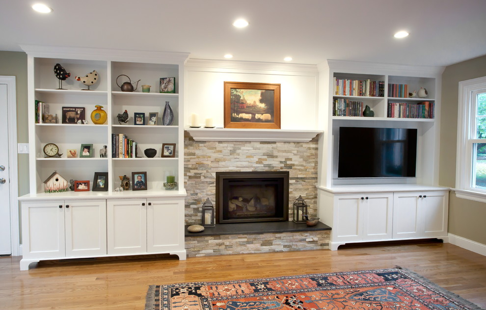 Design ideas for a medium sized classic open plan games room in Philadelphia with beige walls, medium hardwood flooring, a standard fireplace, a stone fireplace surround, a wall mounted tv and brown floors.