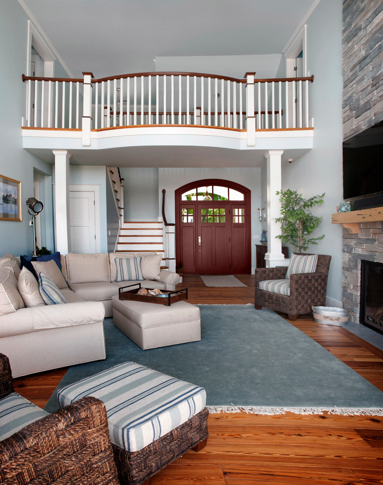 Family room - large coastal enclosed medium tone wood floor and brown floor family room idea in Boston with blue walls, a standard fireplace, a stone fireplace and a wall-mounted tv