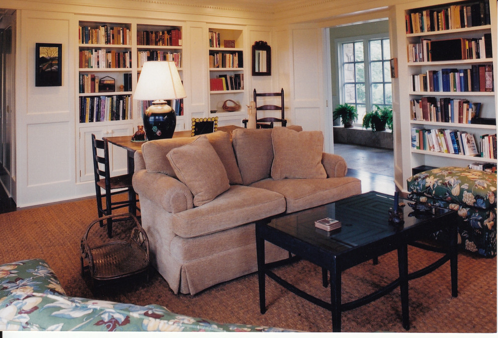 Family room library - large traditional medium tone wood floor family room library idea in Richmond with beige walls and no tv