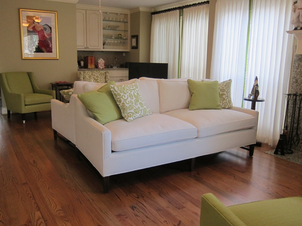 Modelo de sala de estar abierta tradicional de tamaño medio con paredes beige, suelo de madera en tonos medios, todas las chimeneas, marco de chimenea de piedra y suelo marrón