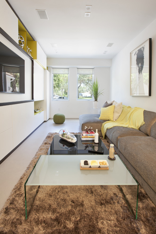 Trendy enclosed family room photo in Miami with white walls and a wall-mounted tv