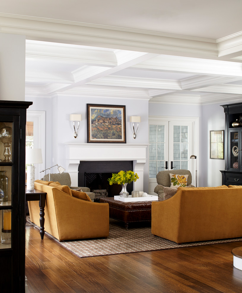 Example of a mid-sized classic medium tone wood floor family room design in New York with blue walls, a standard fireplace and a media wall