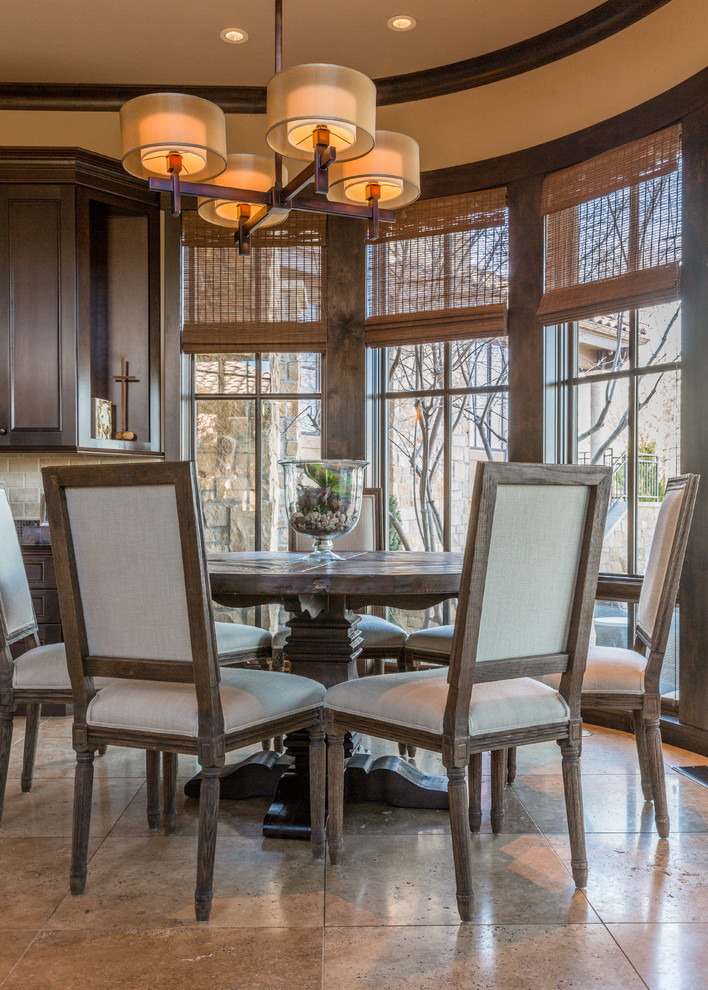 Inspiration for a large classic dining room in Denver with beige walls, limestone flooring, a corner fireplace, a stone fireplace surround and beige floors.