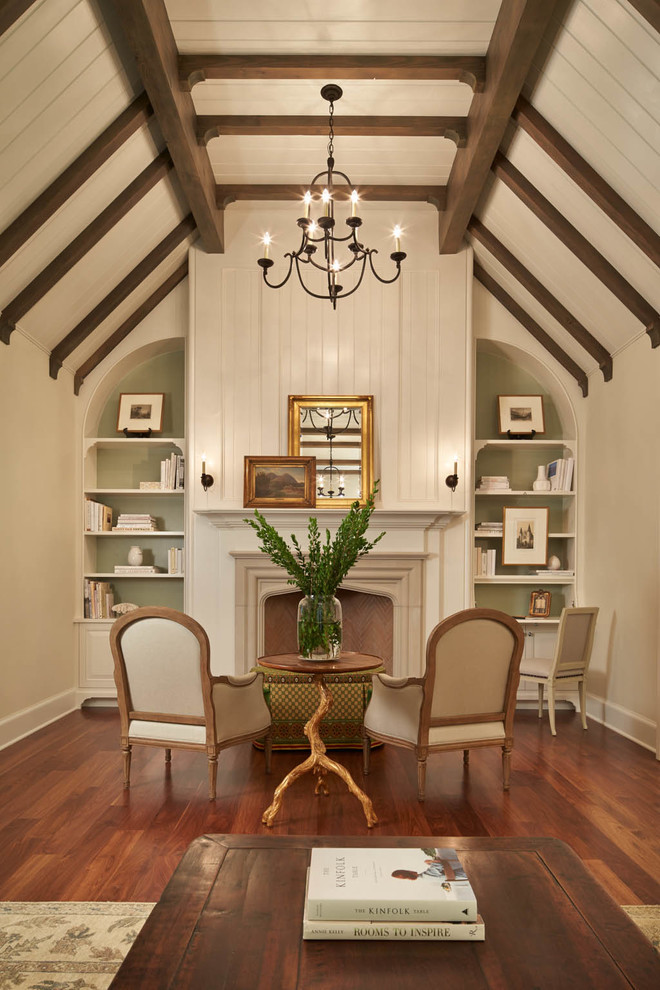 Ejemplo de sala de estar tradicional con paredes beige, suelo de madera oscura y todas las chimeneas