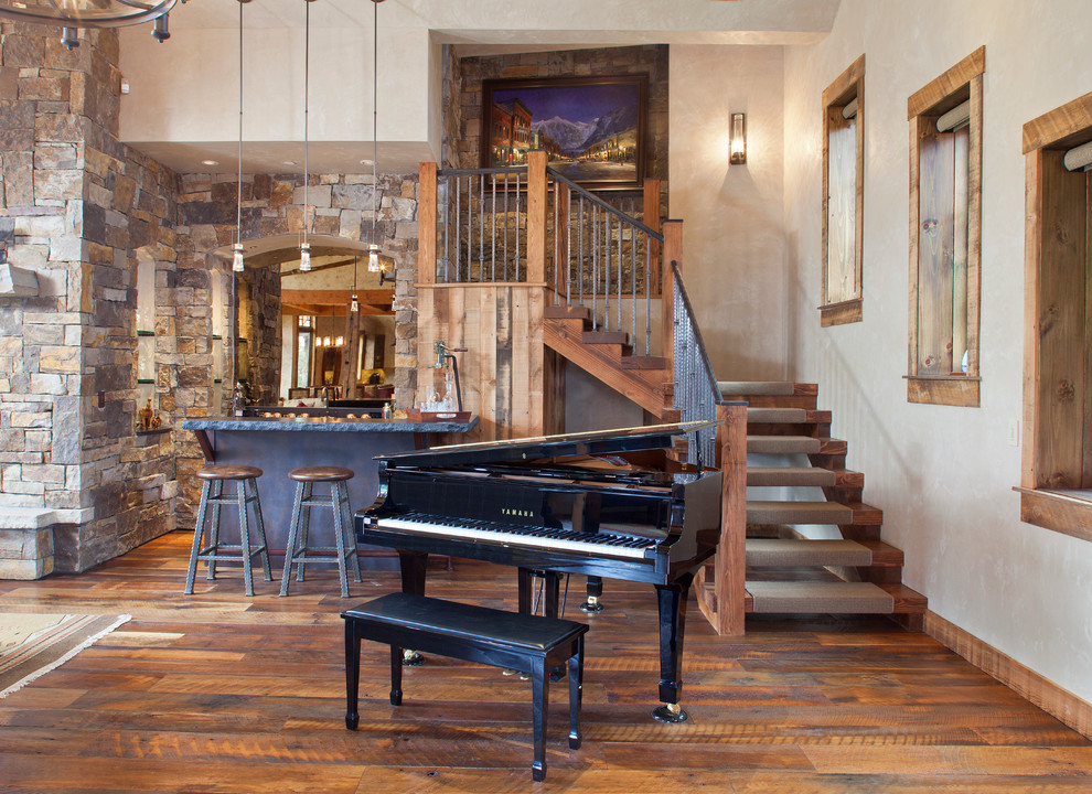 This is an example of a rustic games room in Denver with medium hardwood flooring.