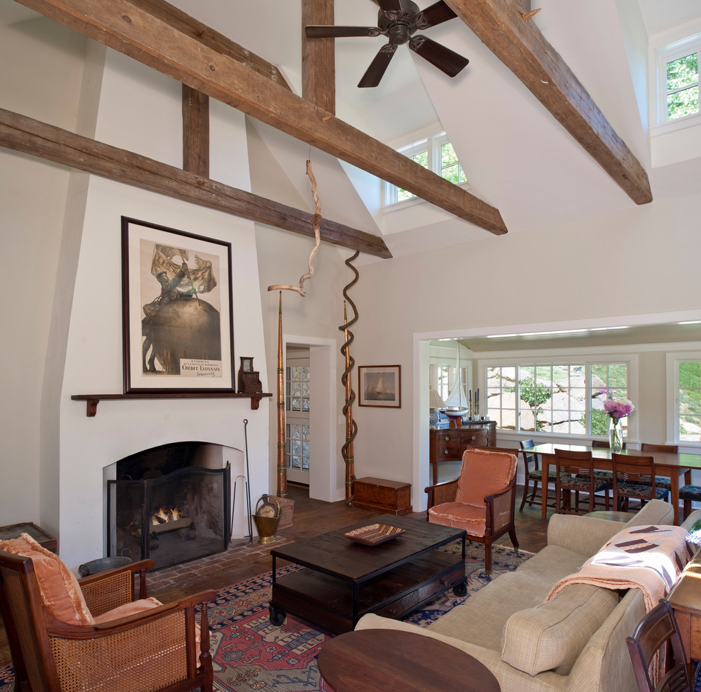 Elegant open concept dark wood floor family room photo in Philadelphia with beige walls, a standard fireplace and no tv